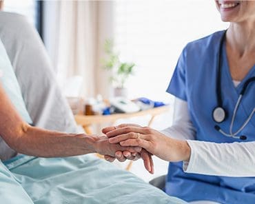 doctor holding hands with the patient