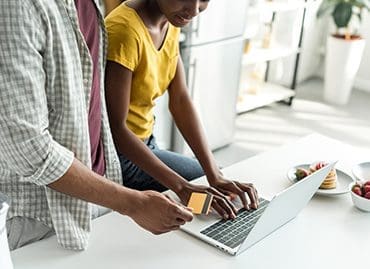 Man and woman using laptop