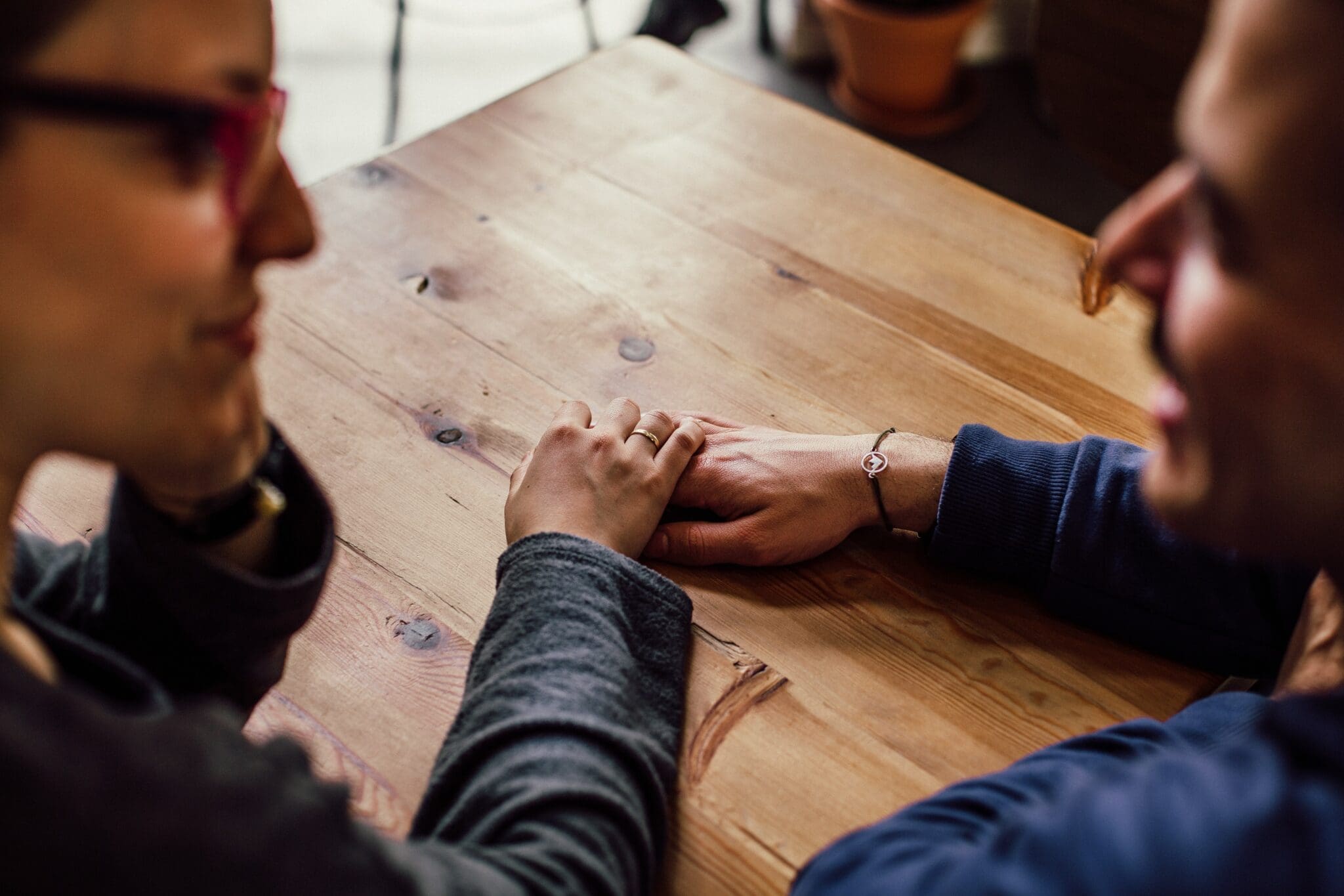 Male and female talk while holding hands