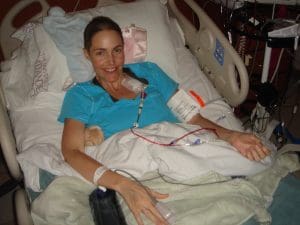 Caroline in a hospital bed having treatment for cancer