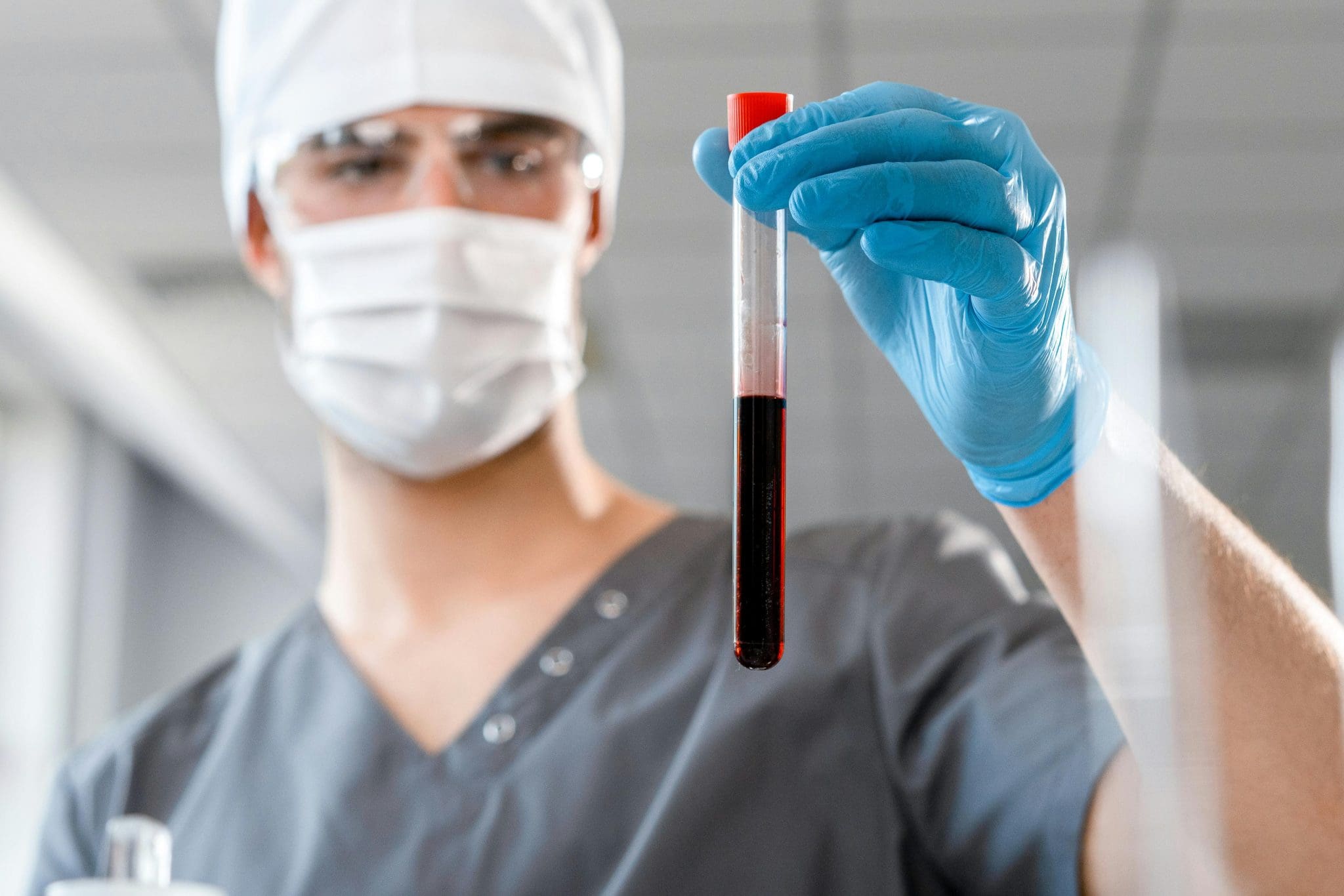 doctor holding a test tube of blood