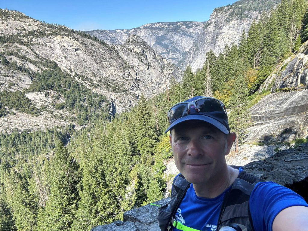 man with mountains behind him