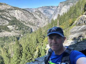 man with mountains behind him