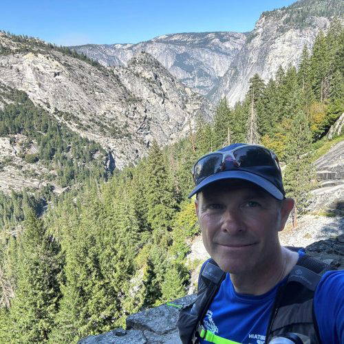 man with mountains behind him